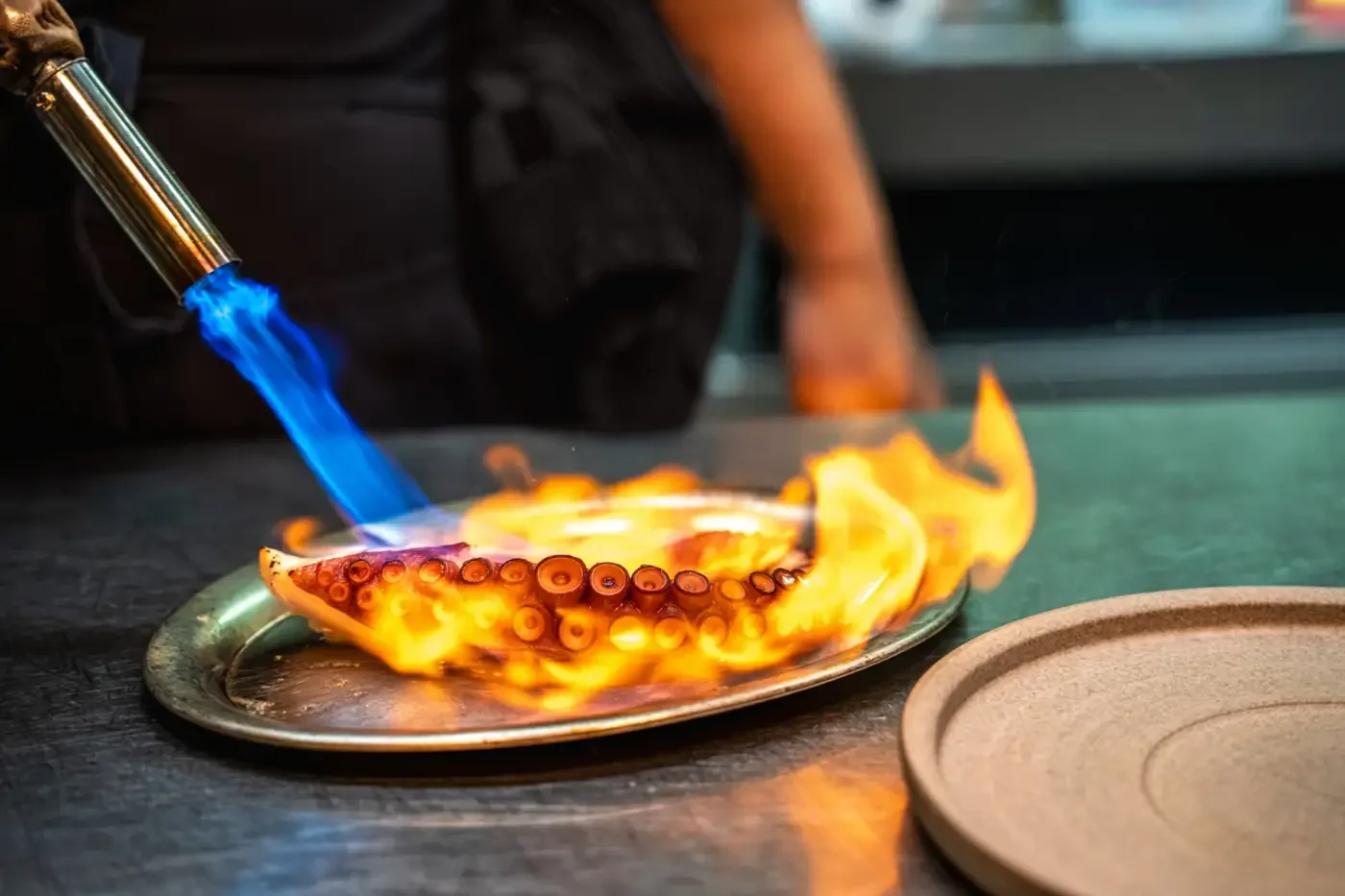 Grilled octopus flamed with a blowtorch